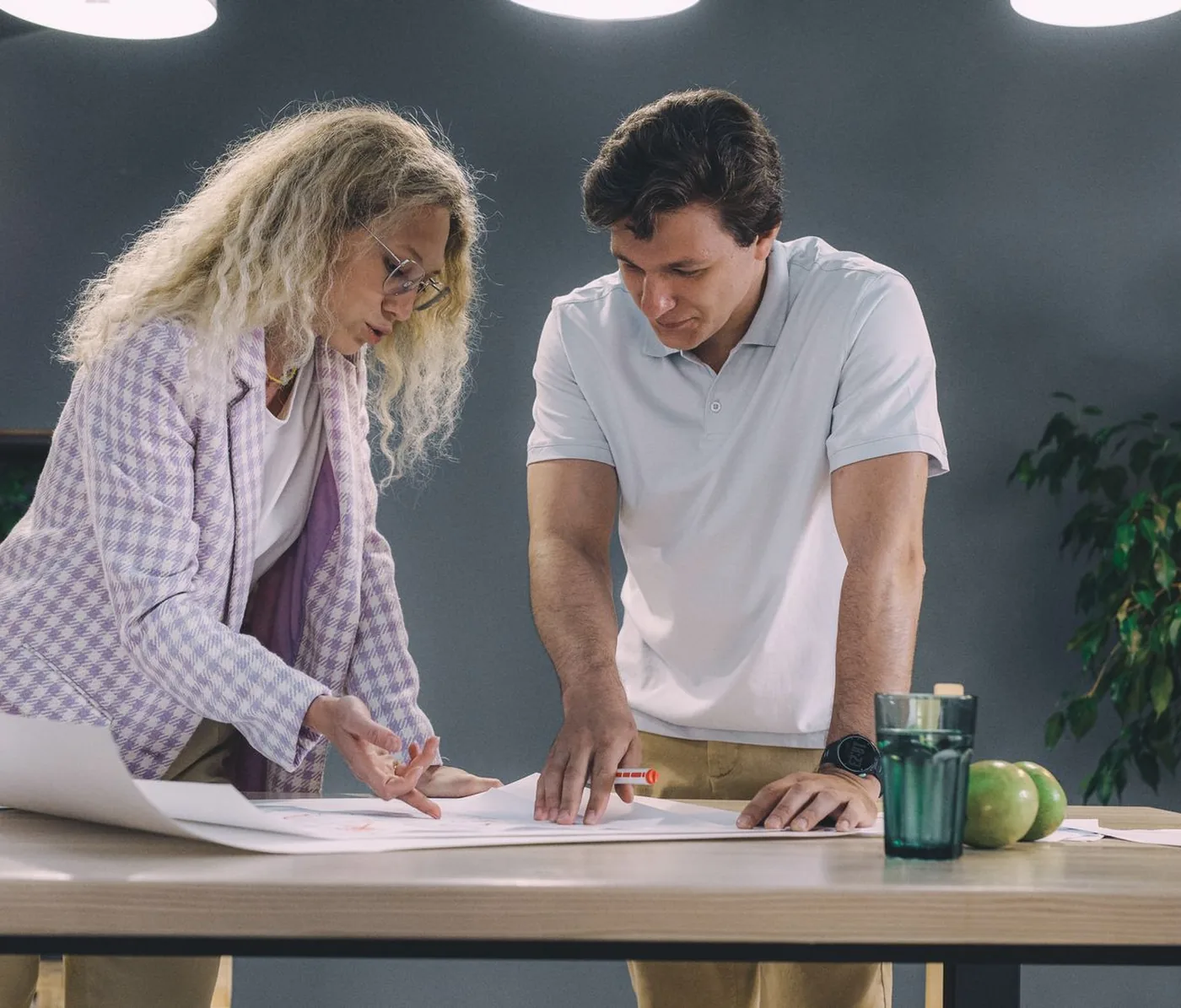 Two people working through a plan together at a table